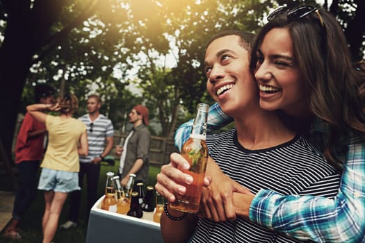 This is what summers all about. a young couple enjoying a party with friends outdoors