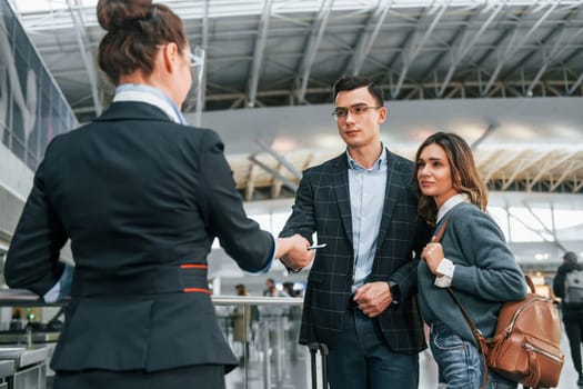 Passing procedure. Young couple is in the airport together.