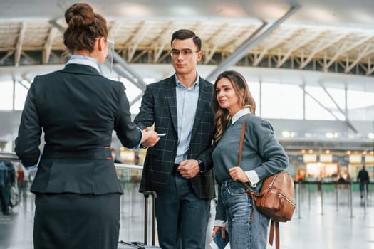 Passing procedure. Young couple is in the airport together.