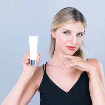 Alluring beautiful perfect cosmetic skin woman portrait hold mockup tube cream or moisturizer for skincare treatment, anti-aging product in isolated background. Natural healthy skin model concept.