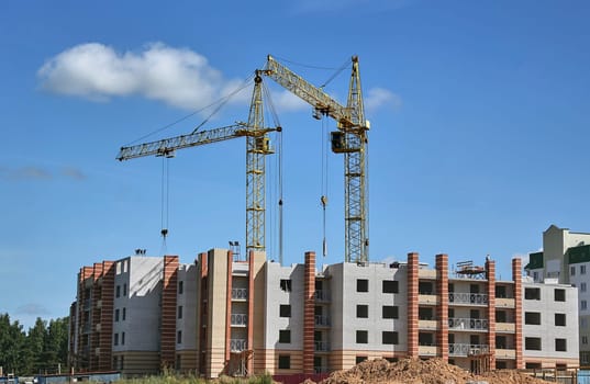 Panoramic view of construction sites and many cranes working in a new construction business.