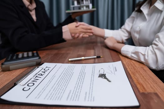 Successful house loan agreement sealed with a handshake. Buyers and agents celebrate the home ownership of property with a sense of accomplishment and satisfaction. Enthusiastic