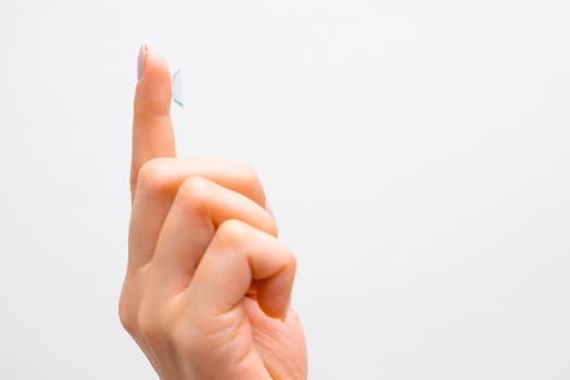 Side view of contact lens for improvement in vision or changes in eye color in womans hands.