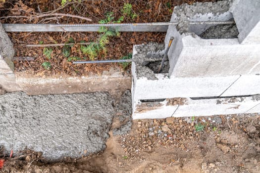 pour concrete from the mixer of the foundation of the building in the ground.