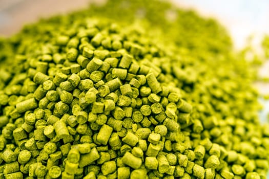 hops in green colored granules for the production of beer in a brewery. High quality photo