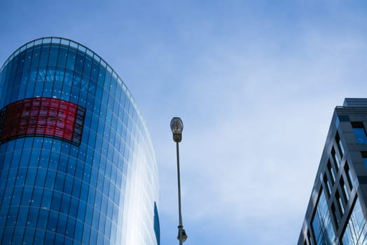 Glass facades of office buildings against a blue sky