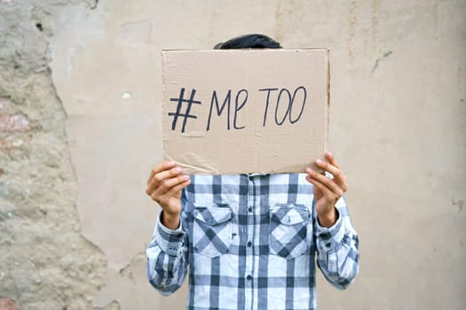 Men alone with depressed expression and showing a paper with a metoo text. Metoo as a new movement. Ideas to stop violence against , sexual harassment and rape, human trafficking