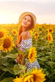 Portrait of young cute woman in straw hat . Outdoors on the sunflower field. Caucasian girl in casual clothes at sunset enjoying the evening in a field of bright sunflowers