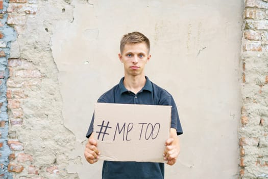 Men alone with depressed expression and showing a paper with a metoo text. Metoo as a new movement. Ideas to stop violence against , sexual harassment and rape, human trafficking. Me too concept