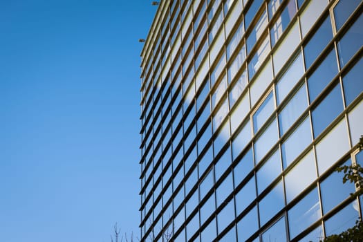 glass building facade with blue sky reflection