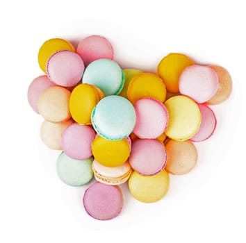 Delicious three multicolored macaroon on a white