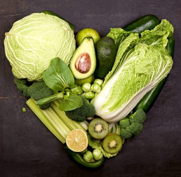 still life with cabbage on a white background in the form of a green heart