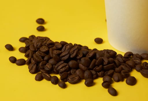 coffee beans near a paper cup with coffee, beans, white background