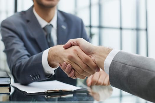 businessman extends his hand for a hand shake