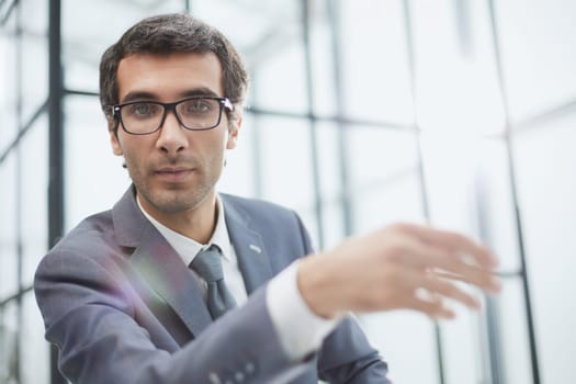 Headshot portrait 30s Caucasian millennial man in glasses sit at desk.