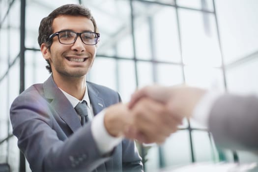 close up.businessman shaking hands with his business partner