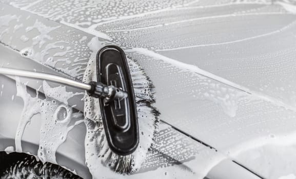 Detail on brush wet from shampoo, cleaning in carwash.