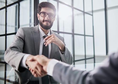 Handshake of two businessmen who enters into the contract to develop a new software