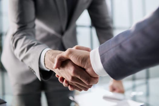 Handshake of two businessmen who enters into the contract to develop a new software