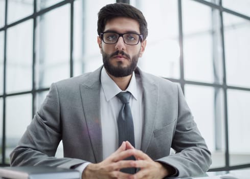 Thoughtful man sitting at the table thinking about solving a problem,