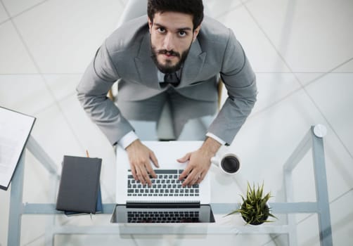 Man working in modern office with laptop