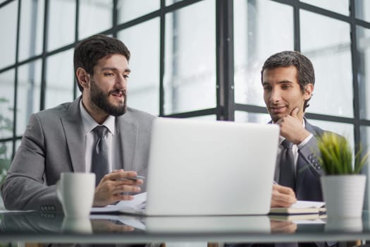 men sitting at a table in a coworking space