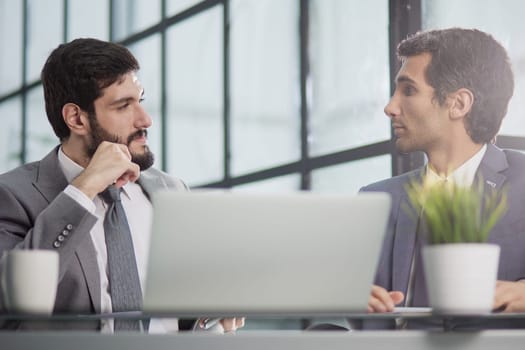 working together in modern office, posing looking at camera