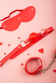 BDSM set in red on a pink background. Love symbol for valentine's day