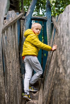 Funny cute happy baby playing on the playground. The emotion of happiness, fun, joy. Smile of a child. boy playing on the playground.