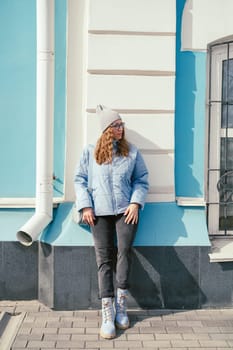 Portrait of a stylish woman in blue jacket. Spring outdoor portrait.