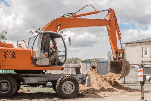 Excavator digging heavy earth work on an industrial machine on a construction site industry.