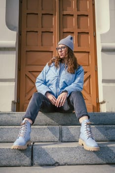 Portrait of a stylish woman in blue jacket. Spring outdoor portrait.