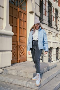 Portrait of a stylish woman in blue jacket. Spring outdoor portrait.