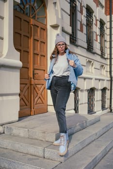 Portrait of a stylish woman in blue jacket. Spring outdoor portrait.