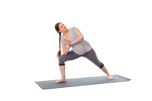 Pregnancy yoga exercise - pregnant woman doing asana Utthita Parsvakonasana - Extended Side Angle Pose isolated on white background