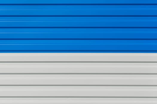 Blue and white horizontal lines sheet metal plate corrugated texture steel fence background.