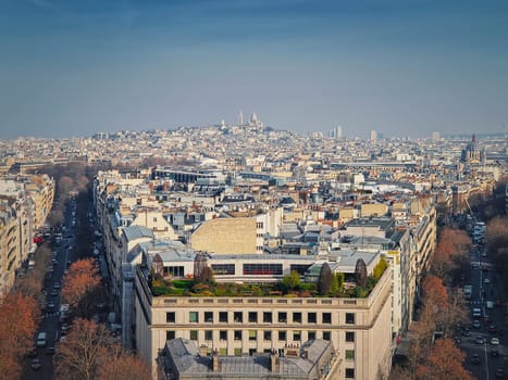 Aerial Paris cityscape with view to Sacre Coeur Basilica of the Sacred Heart, France. Beautiful parisian architecture with historic buildings, landmarks and busy city streets