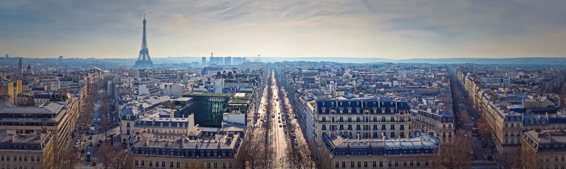 Paris cityscape panoramic view to the Eiffel Tower, France. Beautiful parisian architecture with historic buildings, landmarks and busy city streets