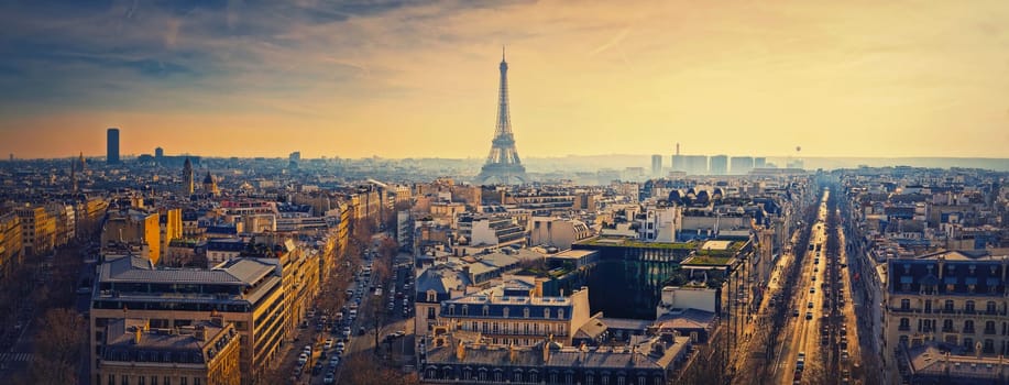 Smog over Paris city, France. Foggy sunset view to the Eiffel Tower due high level of pollution caused by busy urban traffic