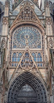 Architectural details of Notre Dame de Rouen Cathedral in the Normandy, France. Outdoor facade view of landmark featuring styles from Early Gothic to late Flamboyant and Renaissance architecture
