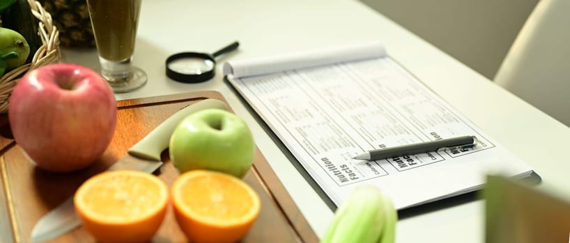 Fruit and vegetable on chopping board with Nutrition Facts on table. High quality photo