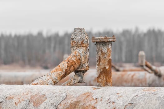 Old steel rusty abandoned pipes of the water cooling pipeline system of the combined heat and power industrial plant.