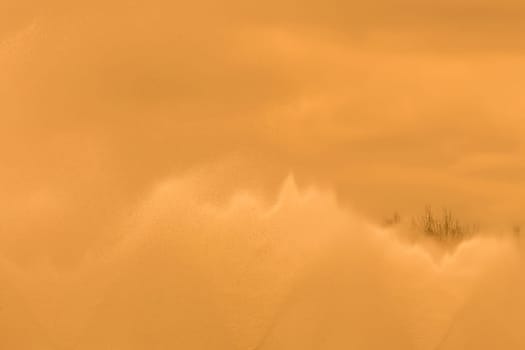 Splashes of water fountain movement of liquid flow against the sky background.