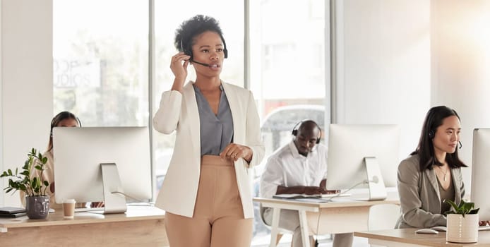 Call center, manager and black woman in office, sales company and coworking customer service agency. Female telemarketing agent talking on headset for consulting, crm advisory and telecom questions.