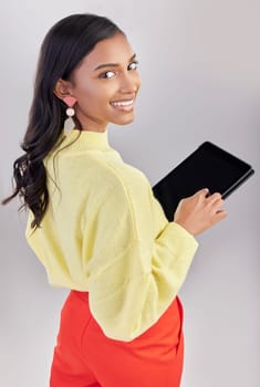 Happy, portrait and a woman with a tablet for an email, communication and the internet. White background, isolated and an Indian girl with technology for social media, business app and the web.