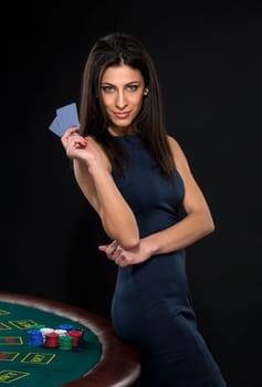 sexy woman with poker cards and chips. Female player in a beautiful black dress