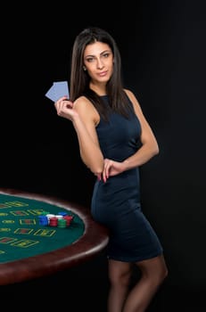 sexy woman with poker cards and chips. Female player in a beautiful black dress