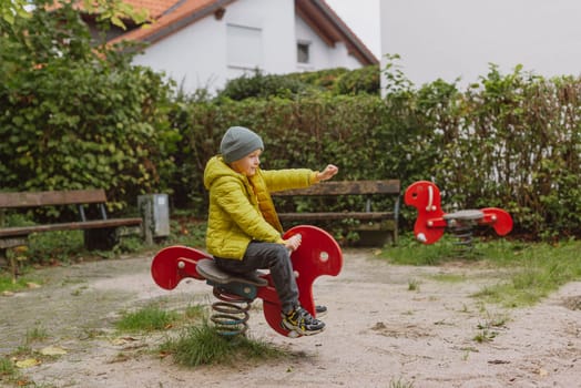 Funny cute happy baby playing on the playground. The emotion of happiness, fun, joy. Smile of a child. boy playing on the playground.