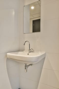 a white sink in a small bathroom with a mirror on the wall above it and a black toilet seat underneath