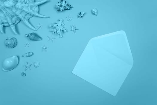 Blue background with envelope and shells and starfish